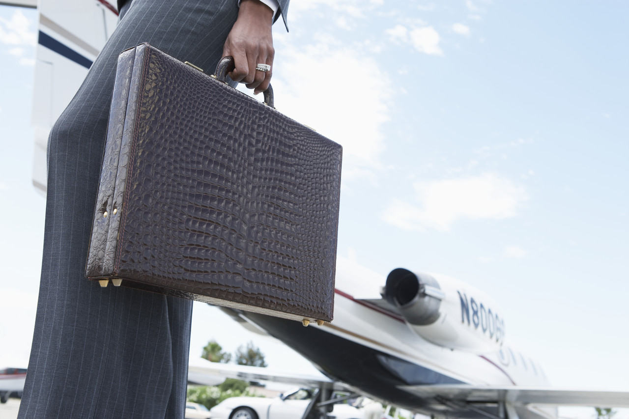Businesswoman Holding a Briefcase --- Image by © Royalty-Free/Corbis